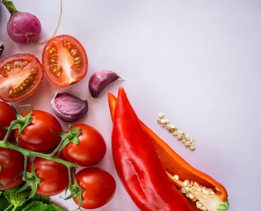 red chili and garlic on white surface